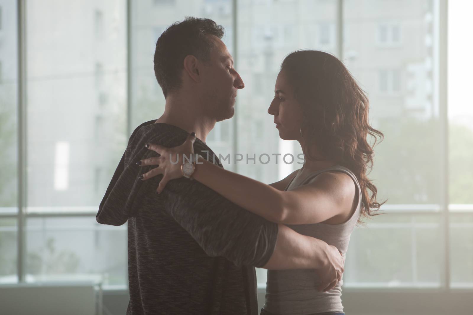Professional dancers reharsing in big studio hall. Dance and passion