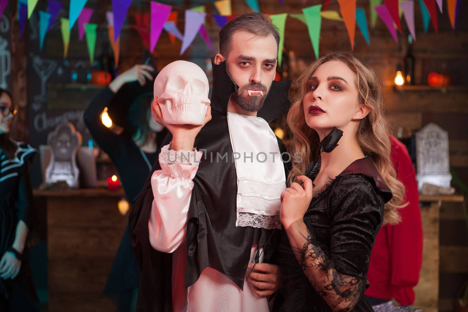 Wounderful couple in halloween costumes at a party by DCStudio