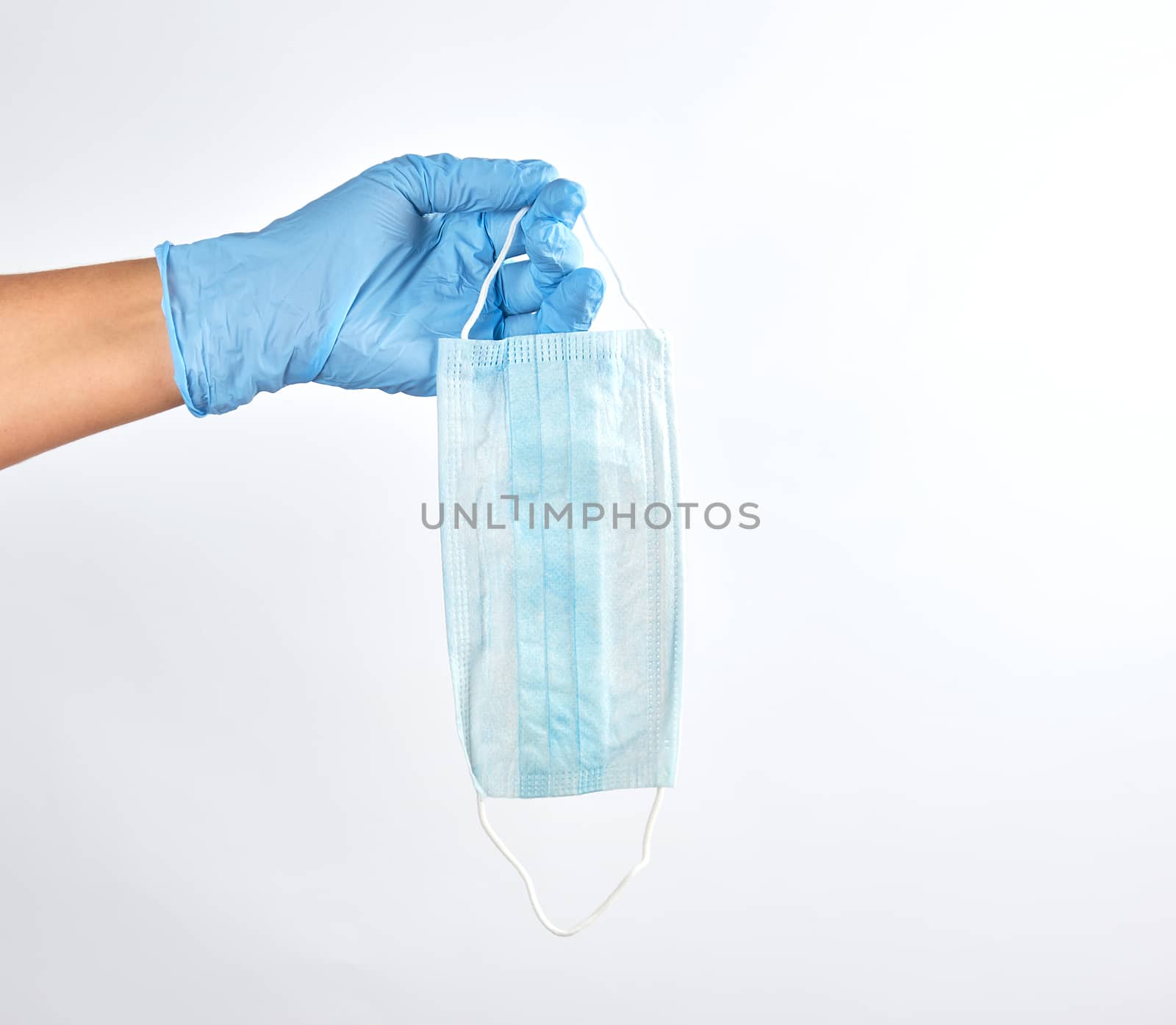 hand holding a medical mask on a white background