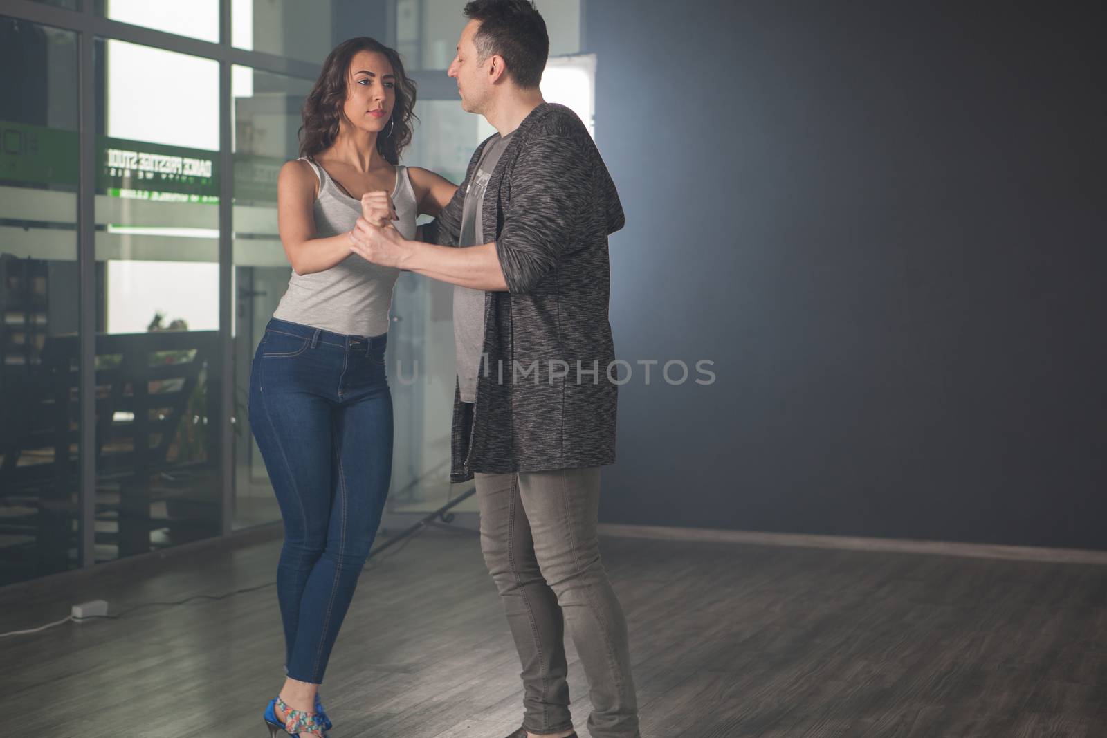 Romantic couple dancing showing their dancing skills of kizomba. Professional dancers. Sexy young woman.