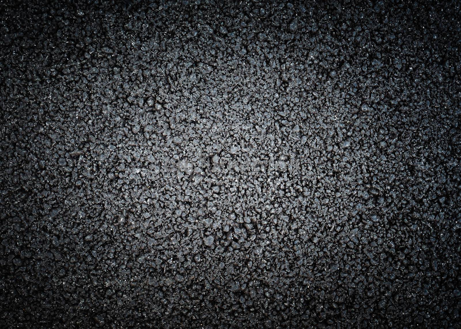 Black asphalt texture, dark background with strong vignette