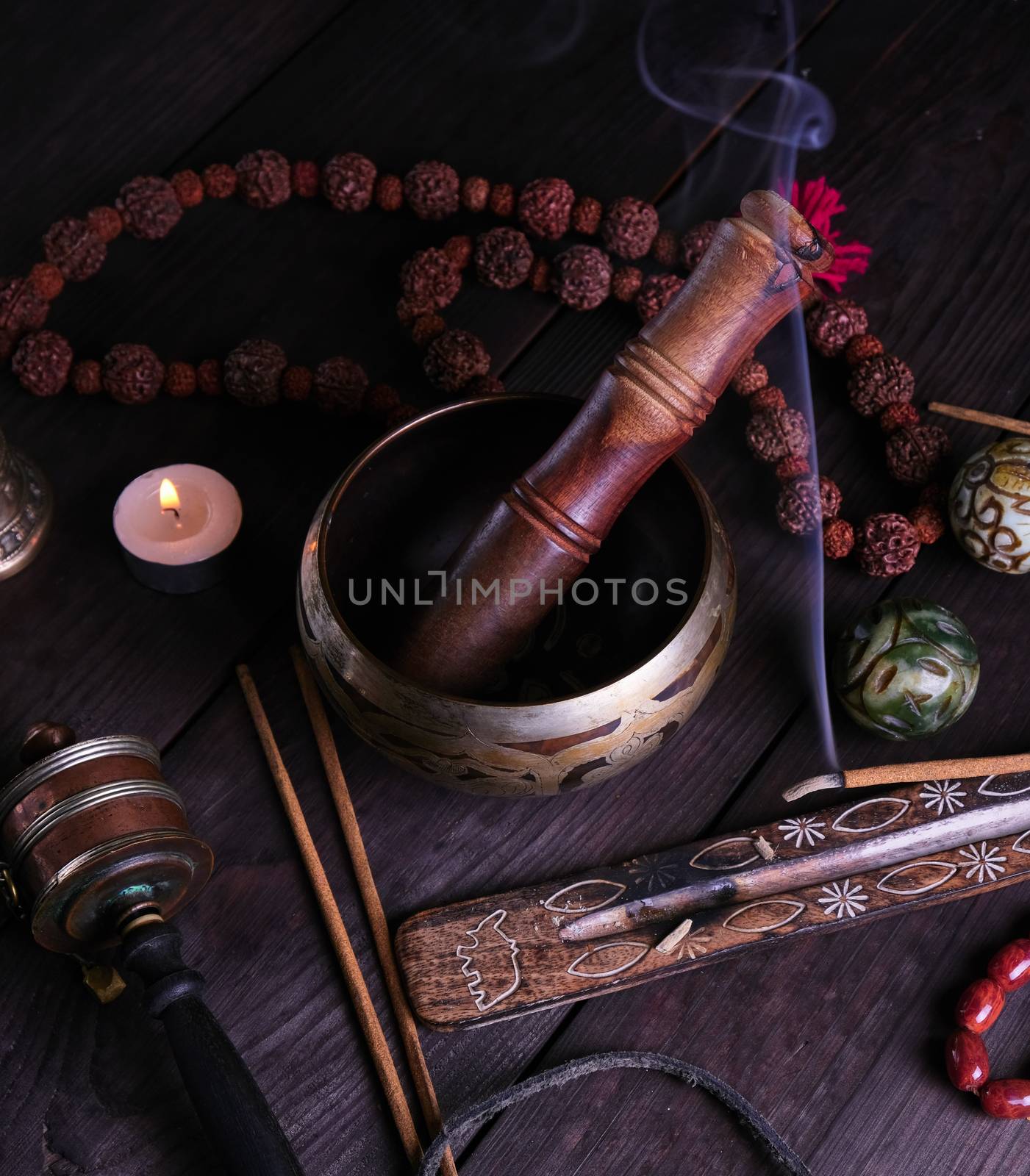 copper singing bowl and a wooden stick by ndanko