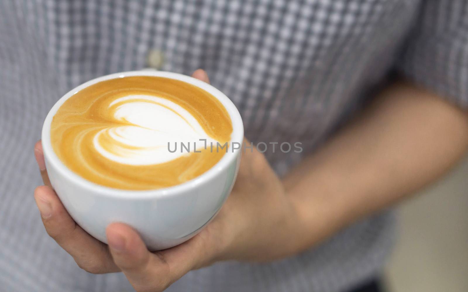 Woman barista holding latte art coffee with heart shape in white by pt.pongsak@gmail.com