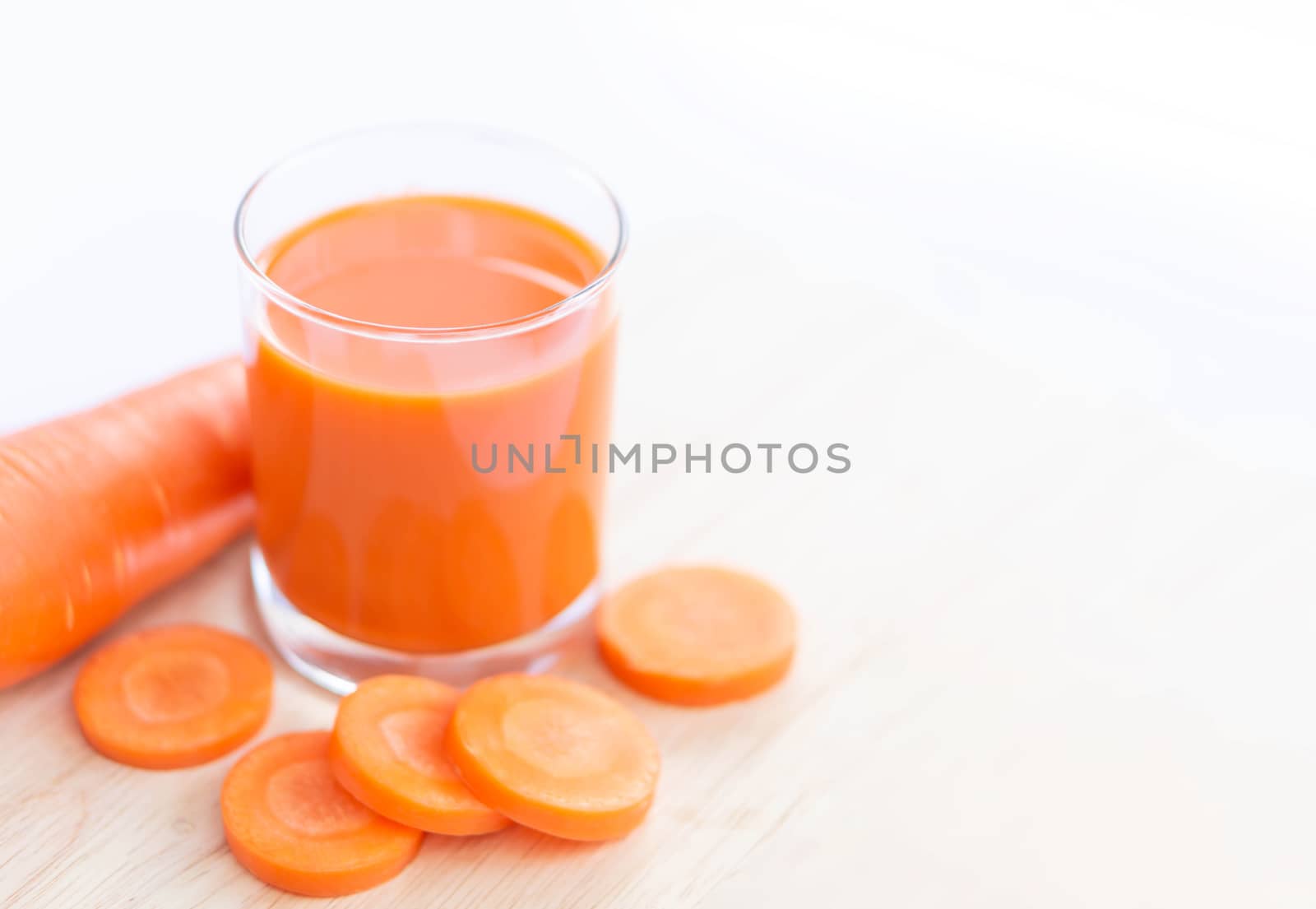 Closeup top view glass of carrot juice and fresh carrot with ove by pt.pongsak@gmail.com