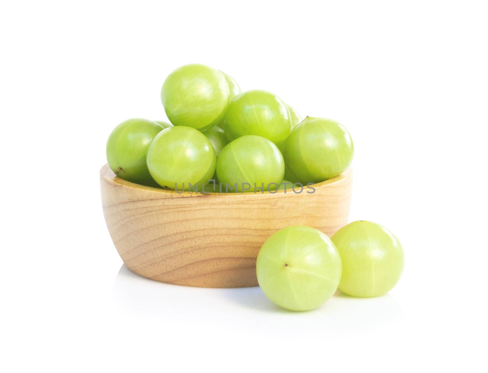 Fresh indian gooseberry in wooden bowl isolated on white background, herb and medical fruit for health care concept