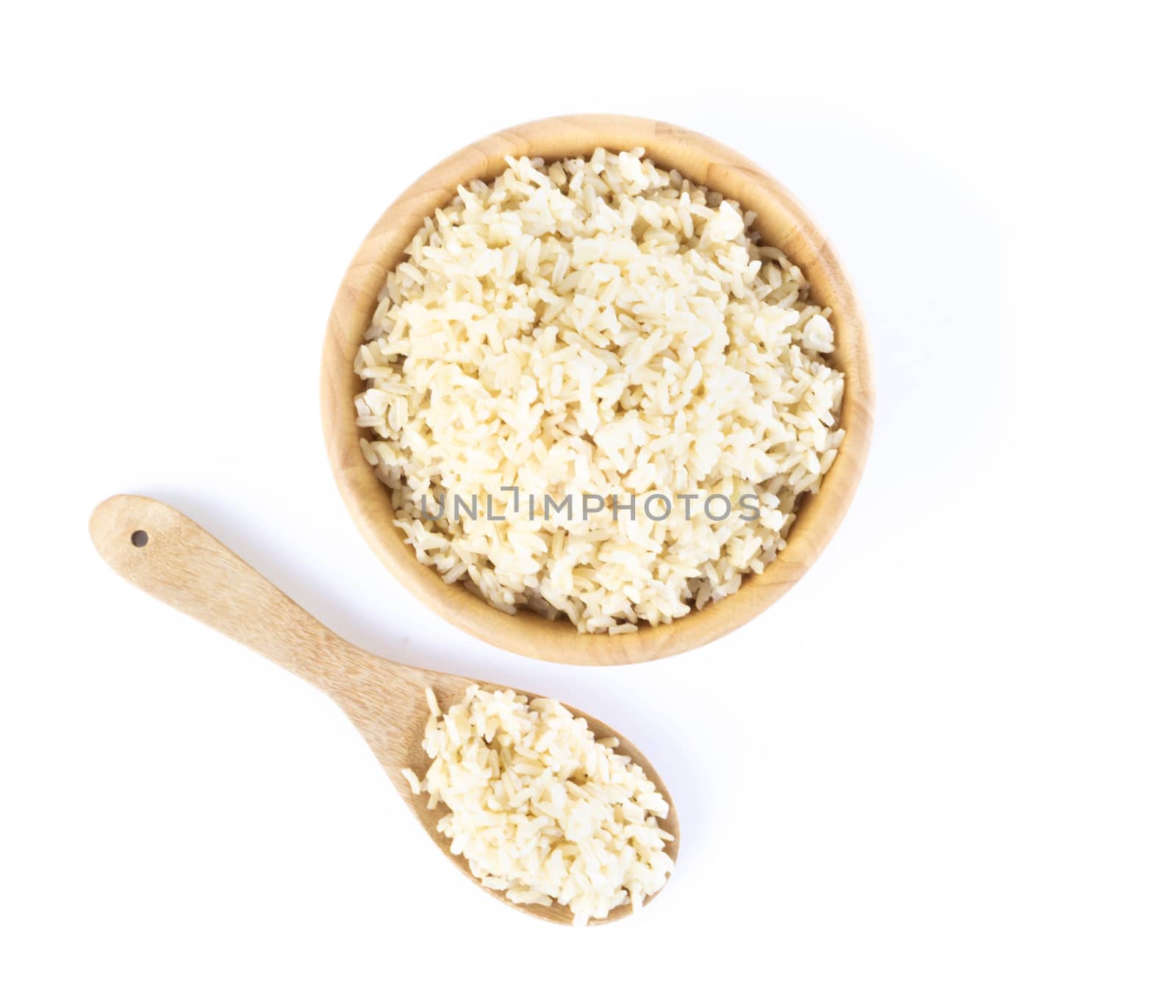 Top view brown rice in the wood bowl and spoon isolated on white background, healthy food conept