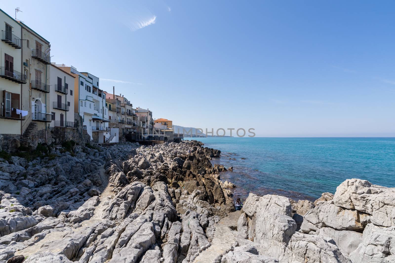 View over the coastline and residential buildings from Bastione di Capo Marchiafava bastion lookout point on a sunny day in Cefalu, Sicily, Italy. by tamas_gabor