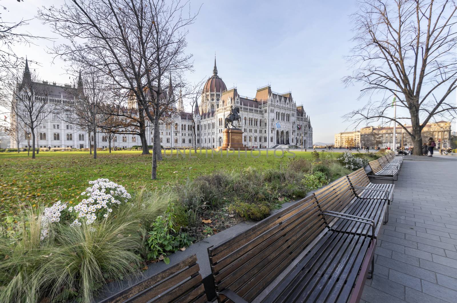 Hungarian parliament building and park from behind on a sunny day in autumn season, angled view.