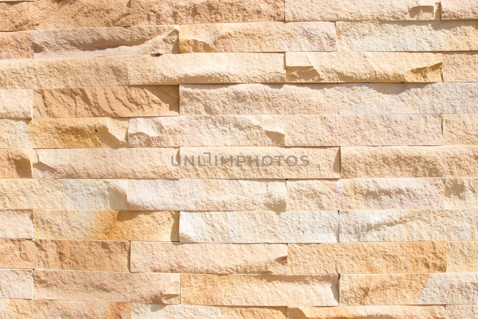 texture of yellow stone wall by Khankeawsanan