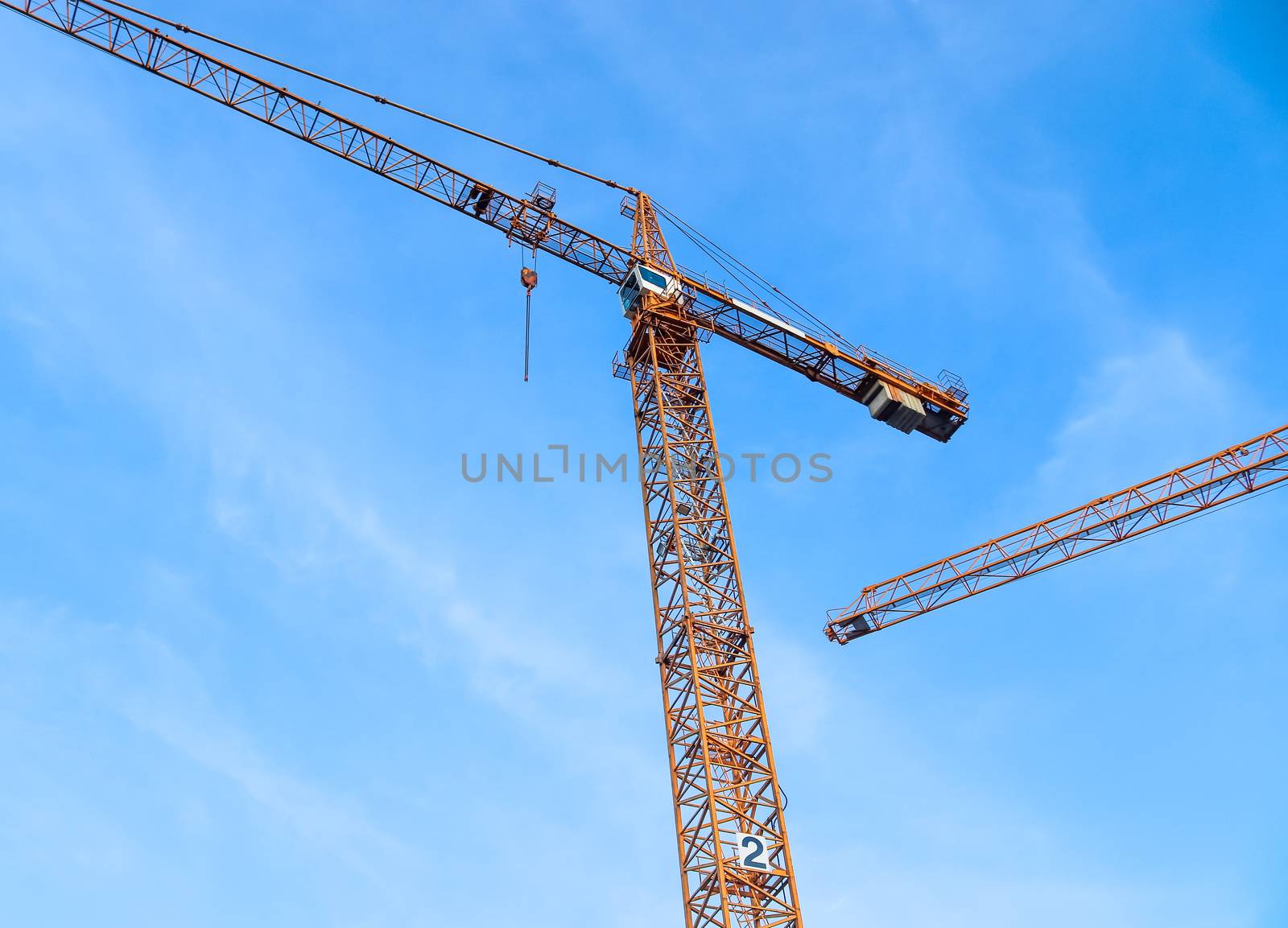 Several cranes on constructions sites at high buildings all over Europe.