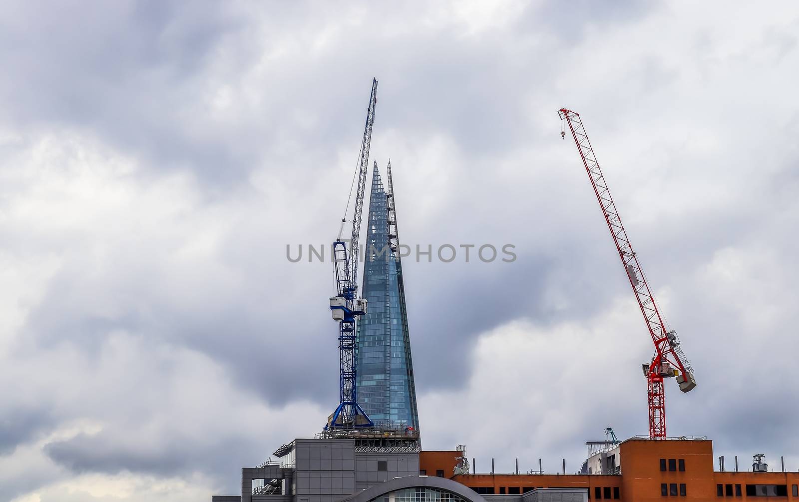 Several cranes on constructions sites at high buildings all over Europe.