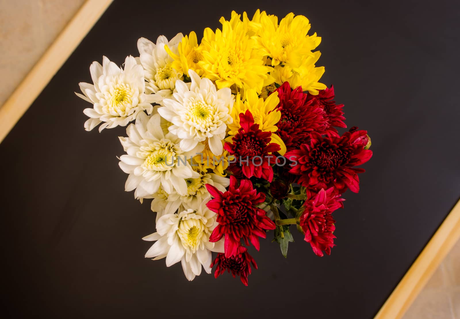 bouquet of yellow  white and red chrysanthemum on black background