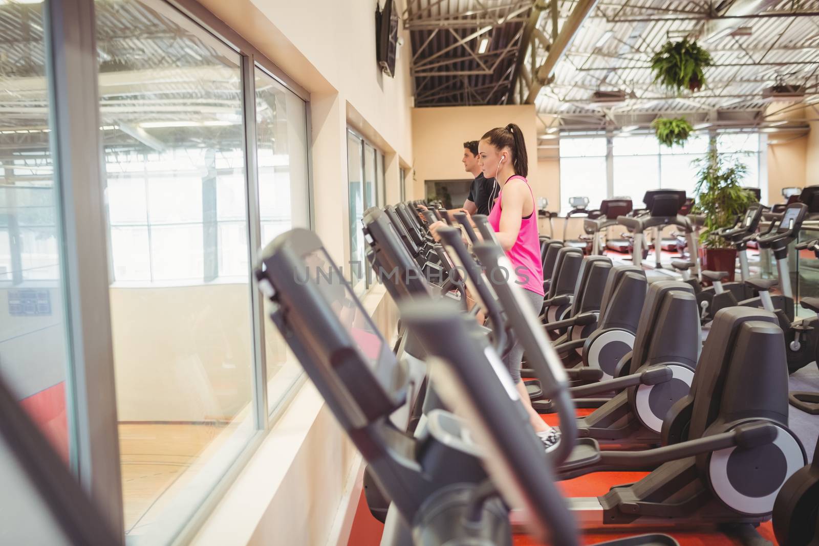 Fit people working out using machines at the gym