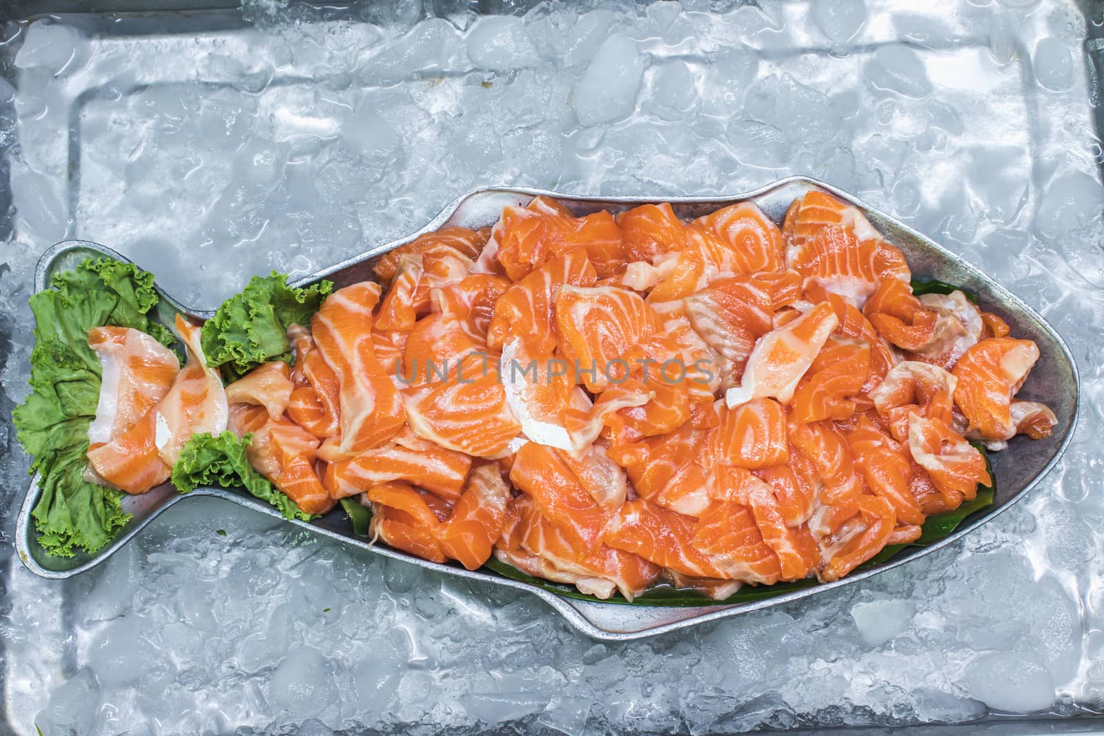 fresh raw sliced salmon in plate on ice by Khankeawsanan