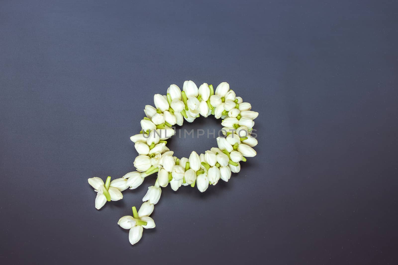 Thai traditional jasmine garland on black wooden table