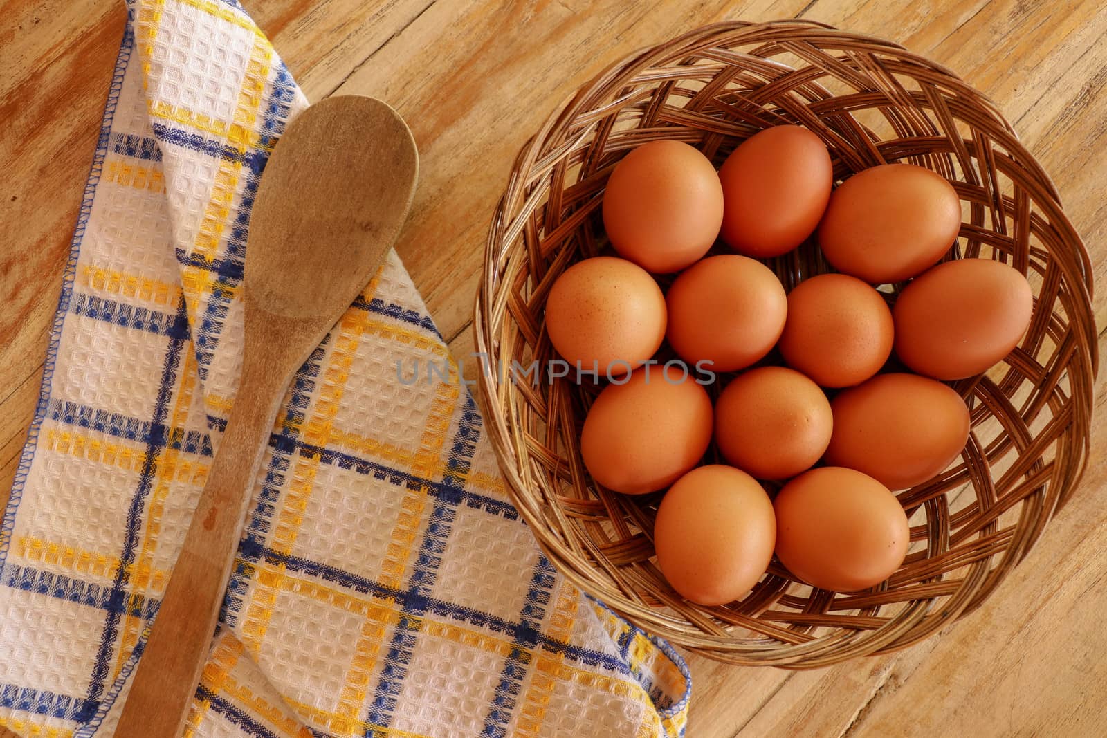 Top view of brown eggs in a wicker basket. Eggs in a wooden bask by Sanatana2008