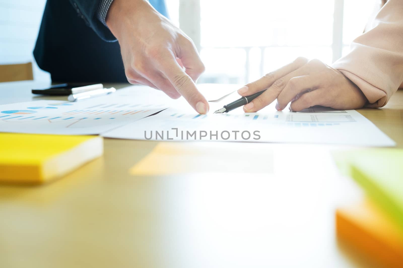 Business concept. Business people discussing the charts and graphs showing the results of their successful teamwork.