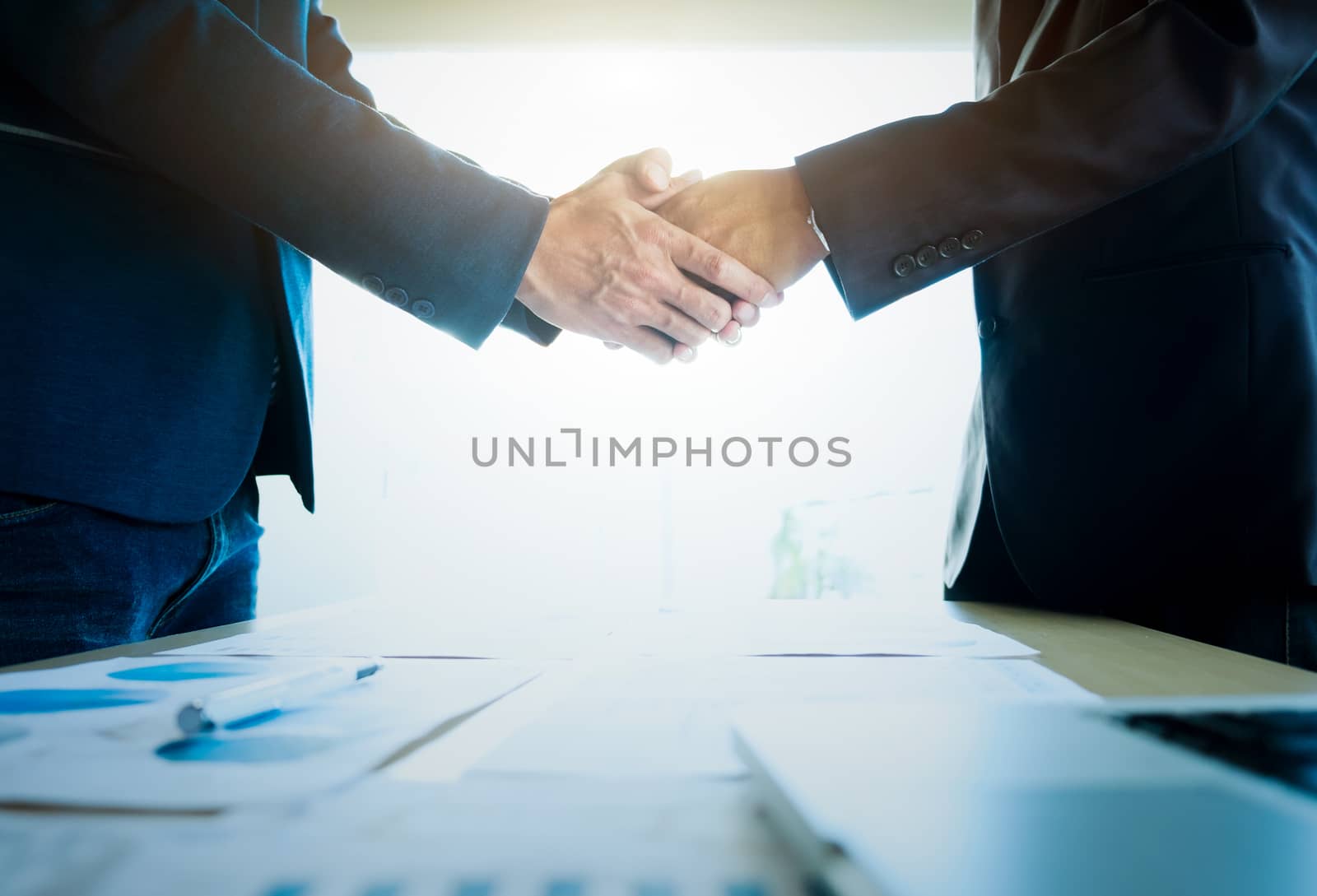 Businessmen shaking hands during a meeting. by ijeab