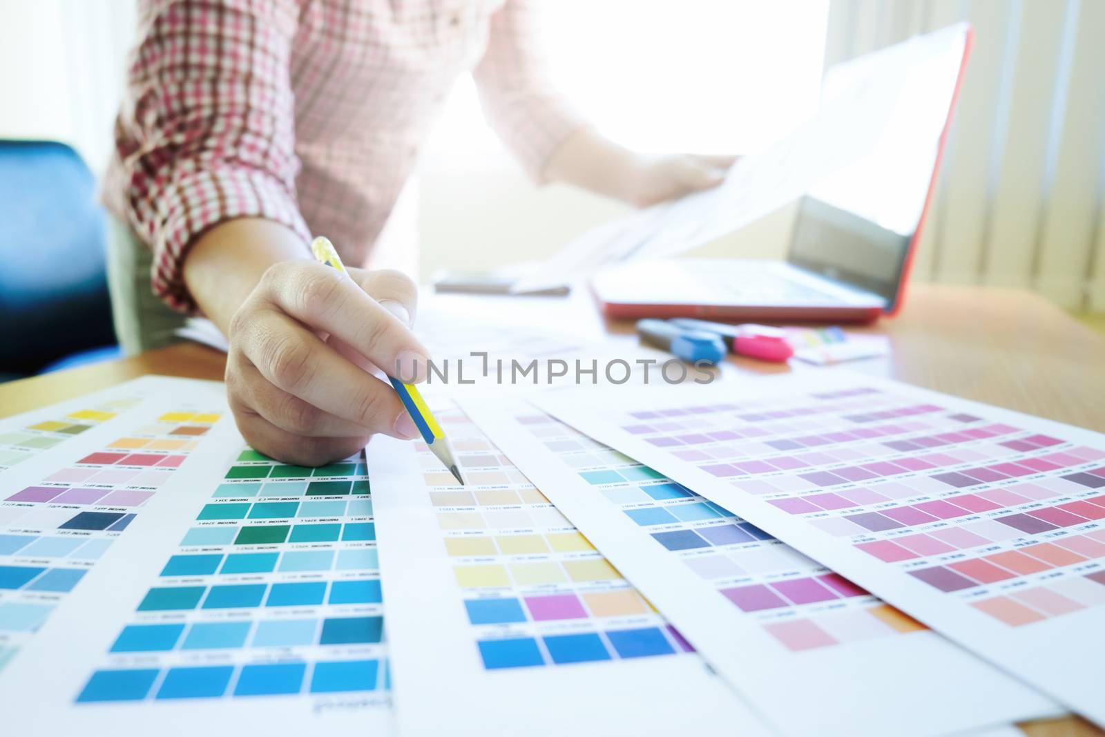 Graphic designer at work. Color swatch samples. by ijeab