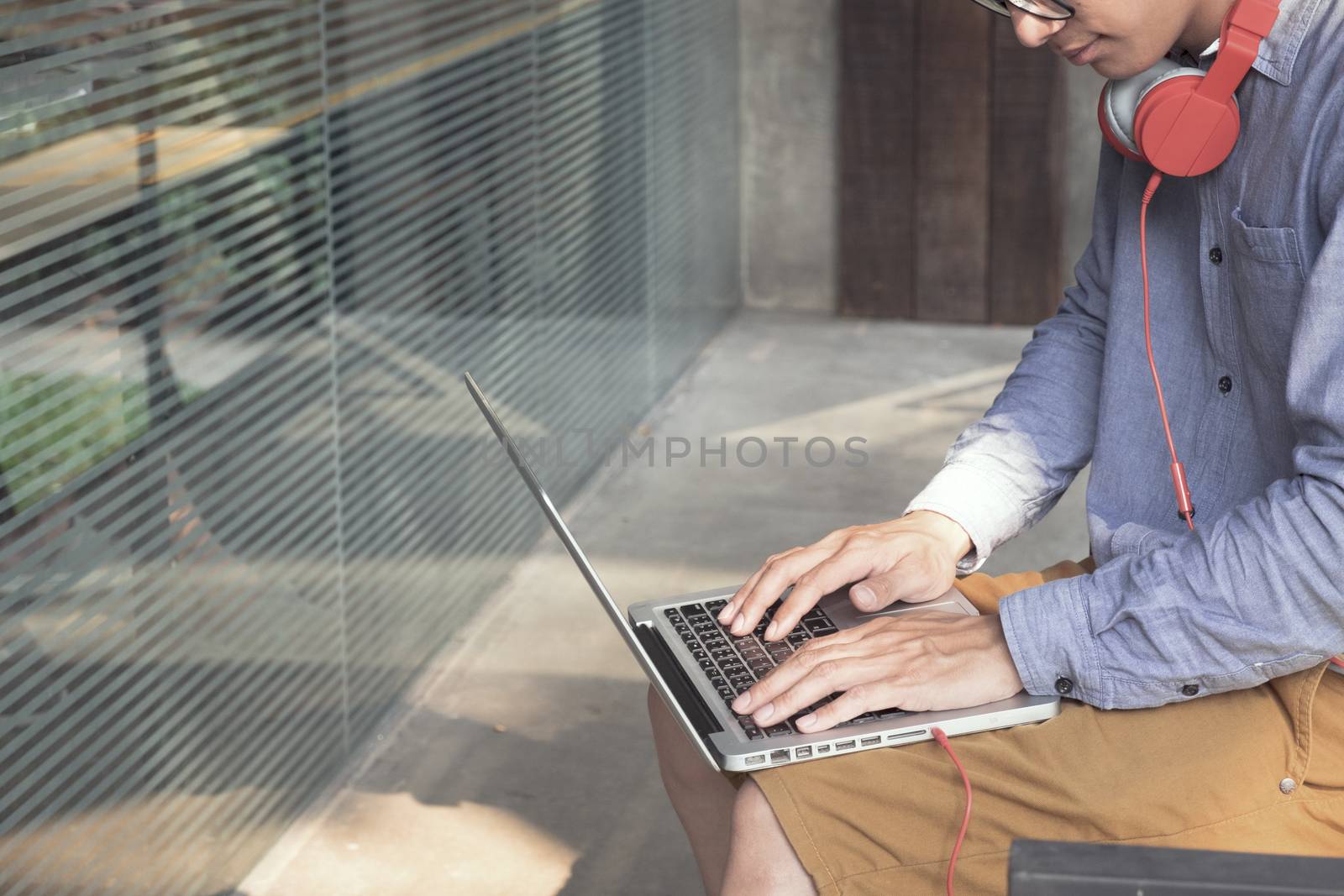 Man finding music in computer laptop. Listening to music concept.