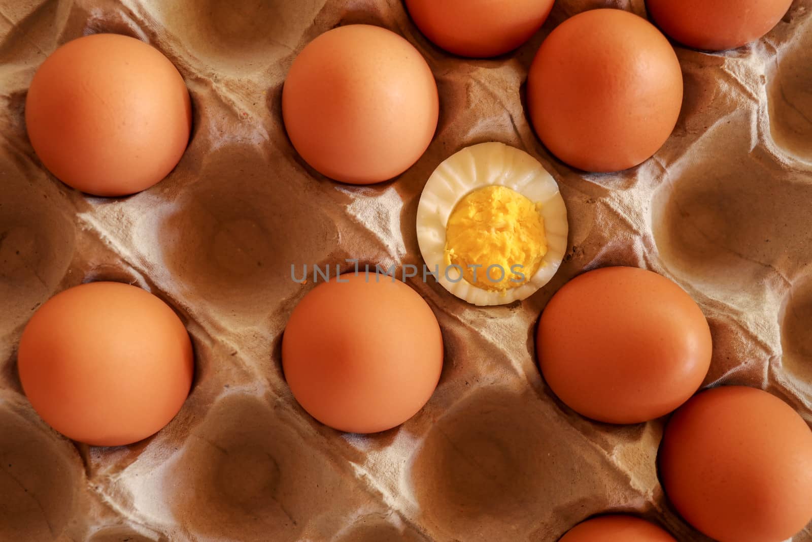 Eggs in paper tray. one soft-boiled. view from top.Boiled halved eggs.