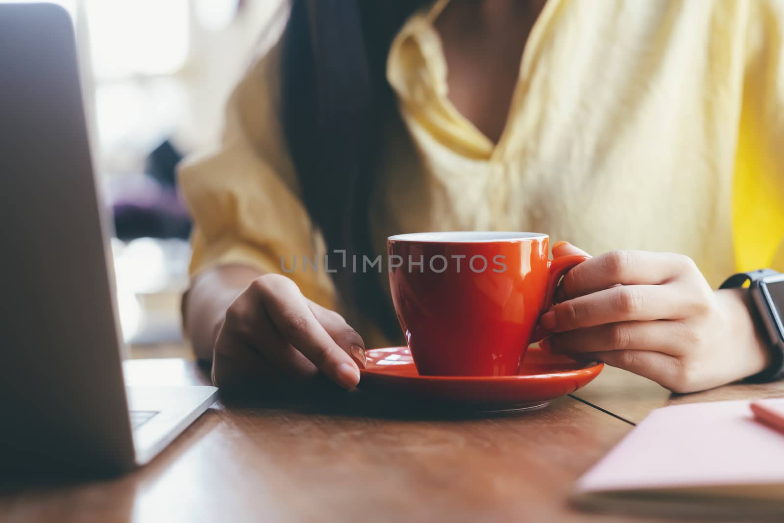 Close up woman holding a red cup of coffee by ijeab