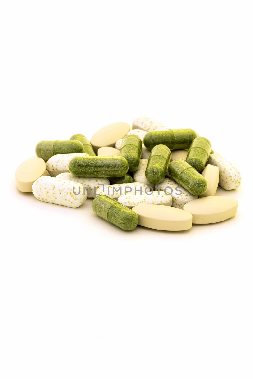 Green chlorophyll capsules on white background 
