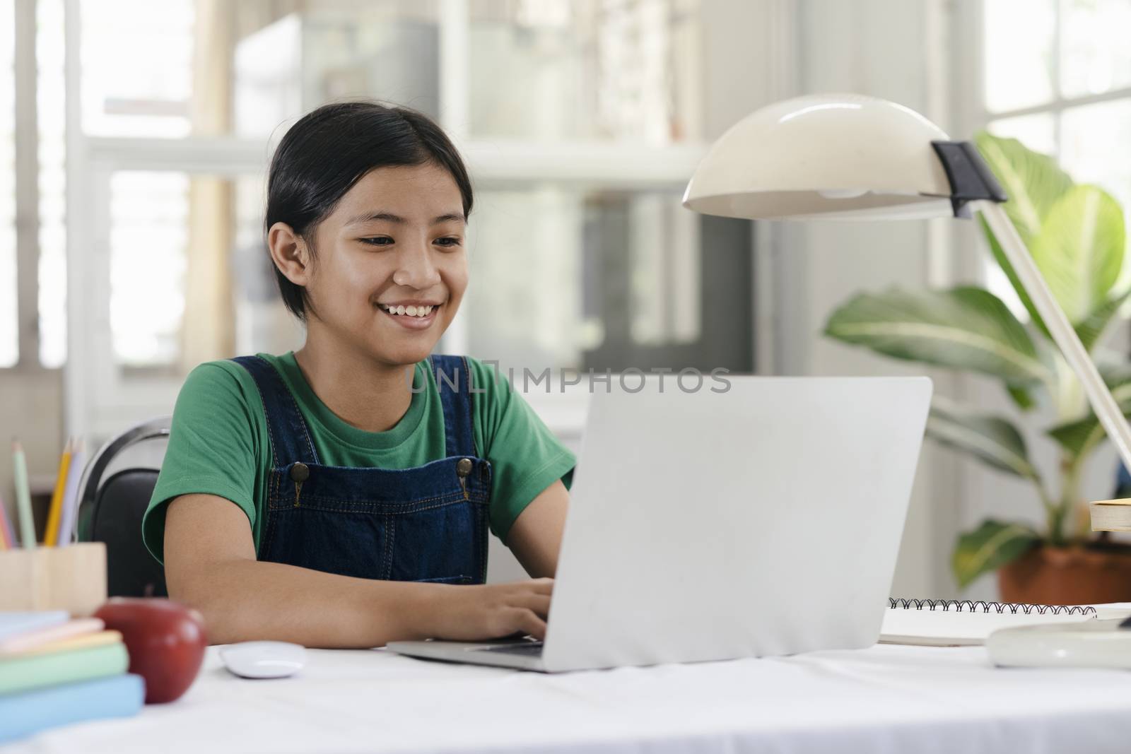 Happy asian girl learning online at home by ijeab