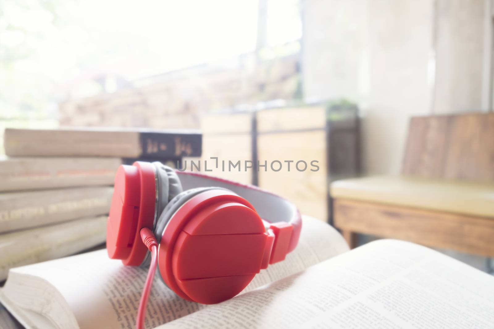 Red headphone on book by ijeab