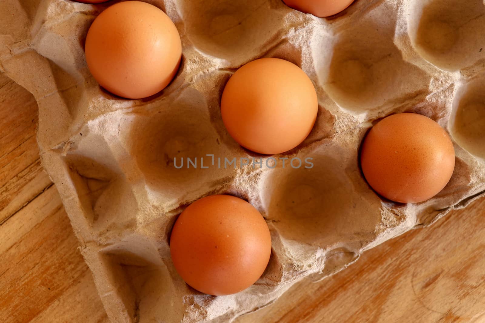 Thirty brown chicken eggs in a cardboard tray packaging. Raw fresh hen eggs in a carton box. Egg pattern background for easter, breakfast, cuisine. Top view