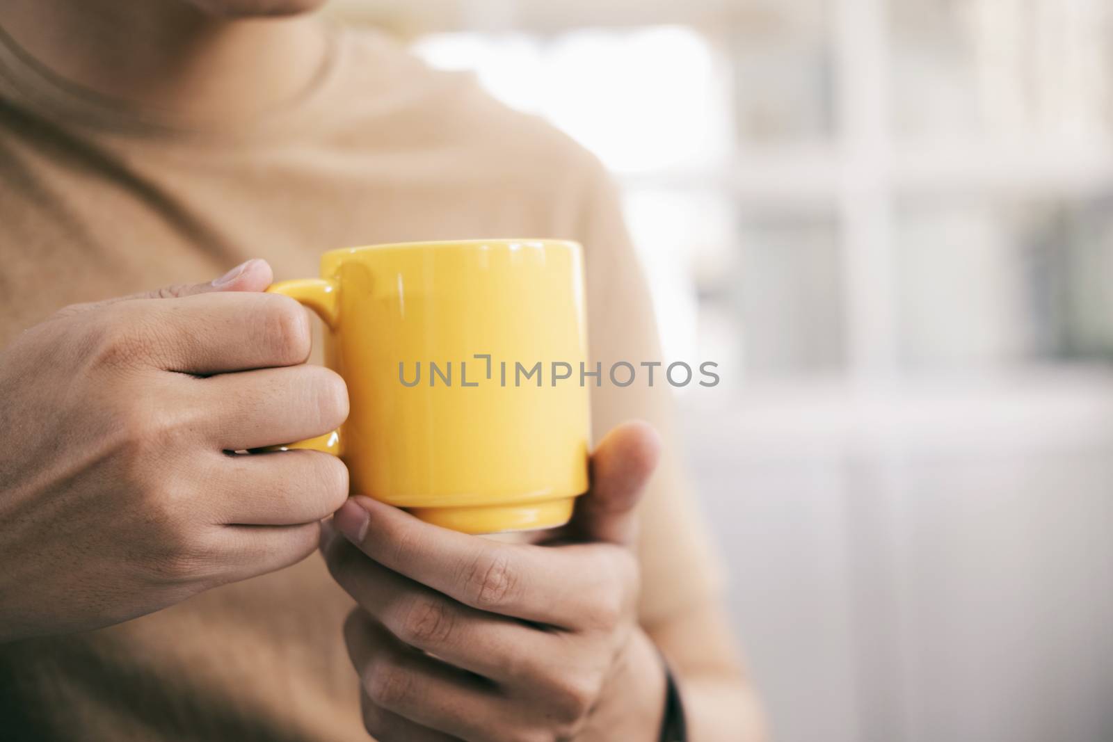 Close up man hands holding a cup of coffee by ijeab
