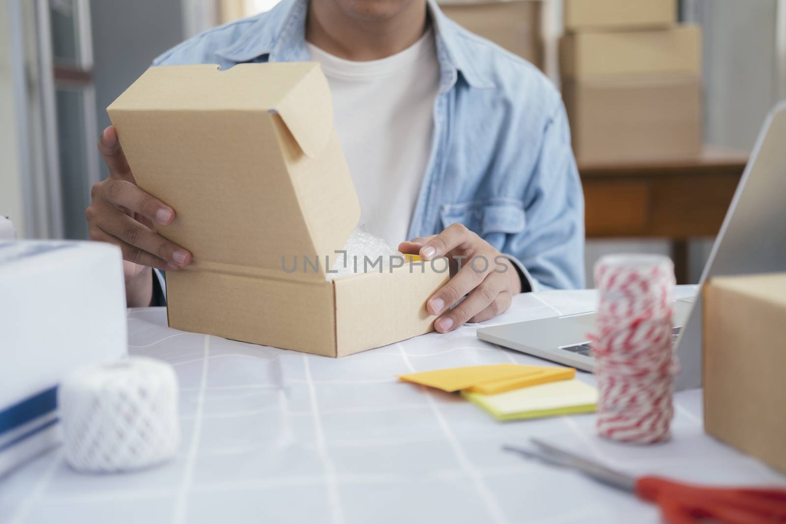 Online small business owner. Young startup entrepreneur online small business owner working at home, packaging and delivery situation. 