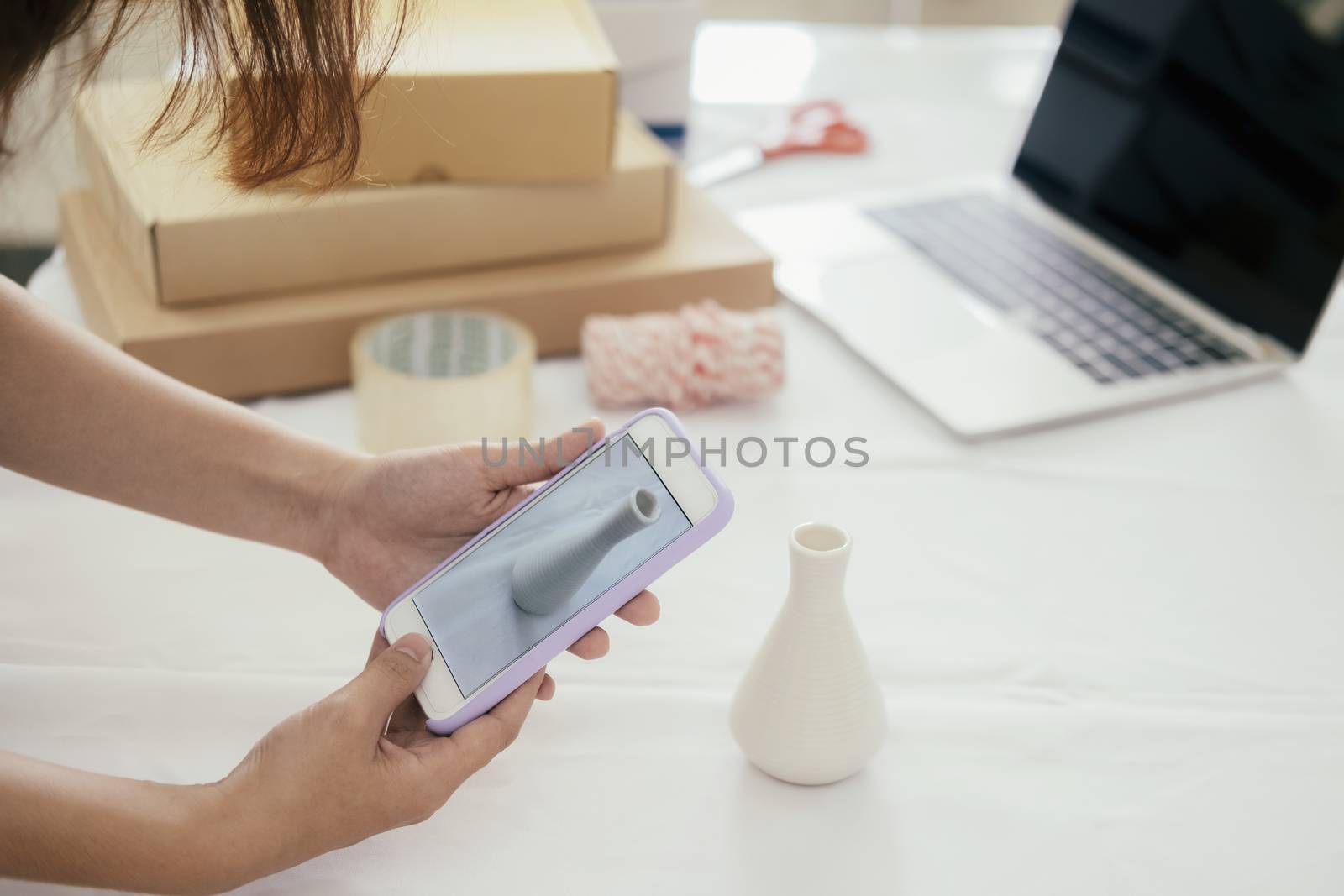 Online seller owner take a photo of product for upload to websit by ijeab