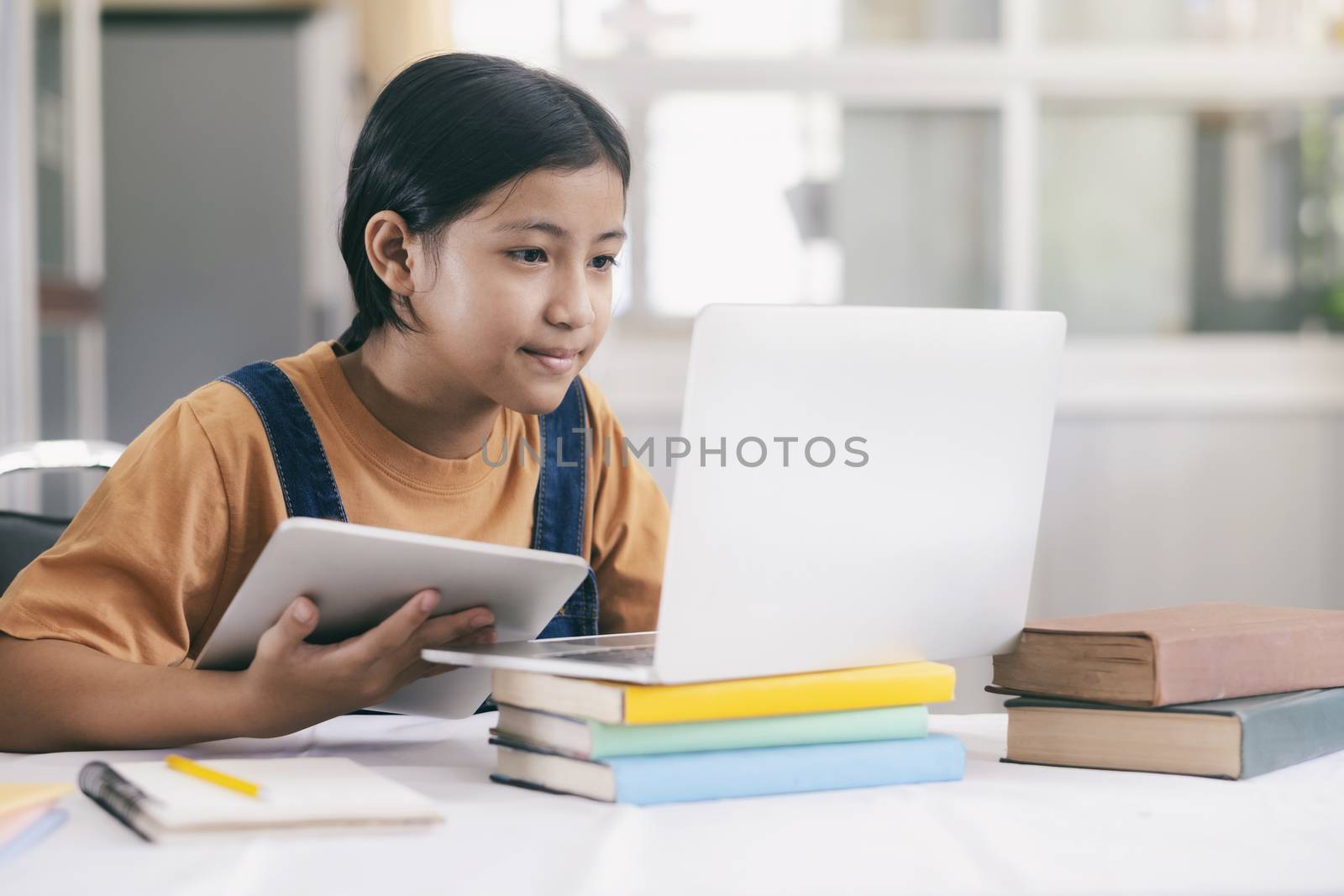 Happy asian girl learning online at home by ijeab