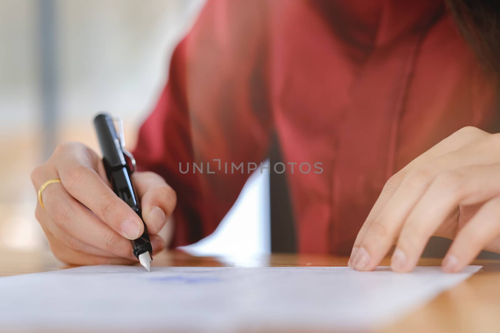 Businesswoman signing a contract document making a deal. by ijeab