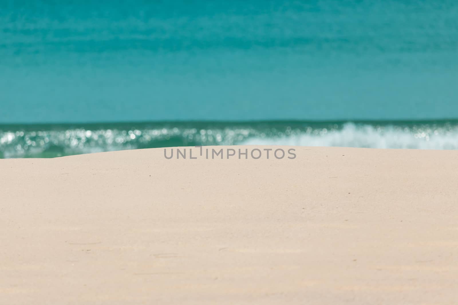 white sandy beach and turquoise sea water on sunny day