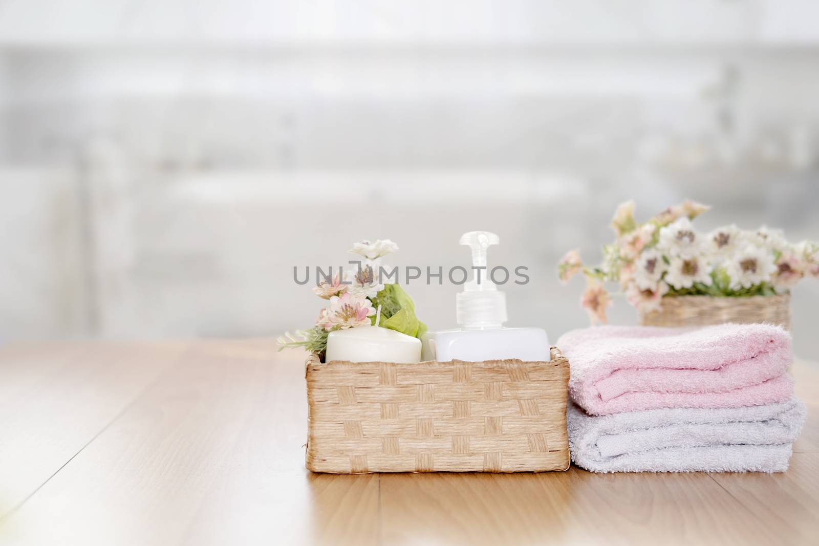 Towels on wooden top table with copy space on blurred bathroom b by ijeab