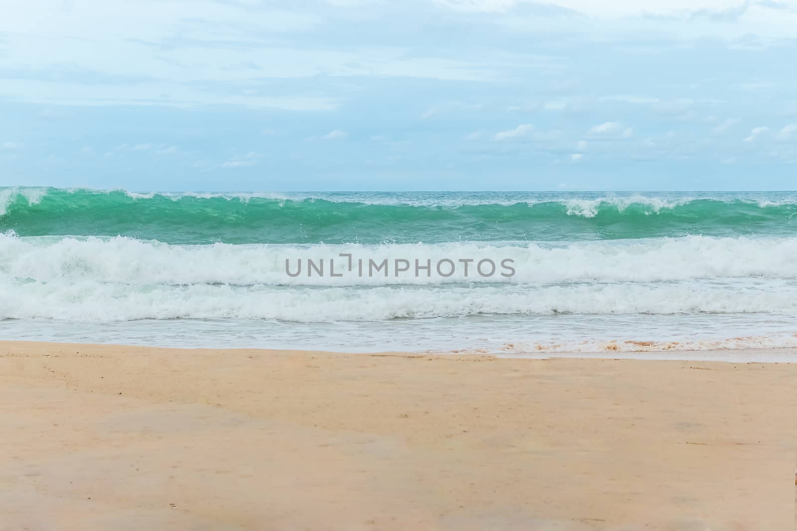 sandy beach blue sky and white formy wave by Khankeawsanan