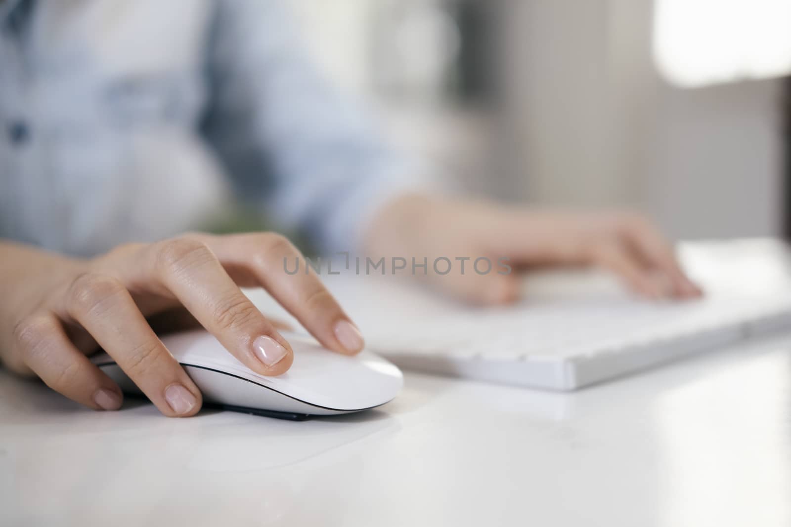 Closeup woman using computer mouse with computer keyboard by ijeab