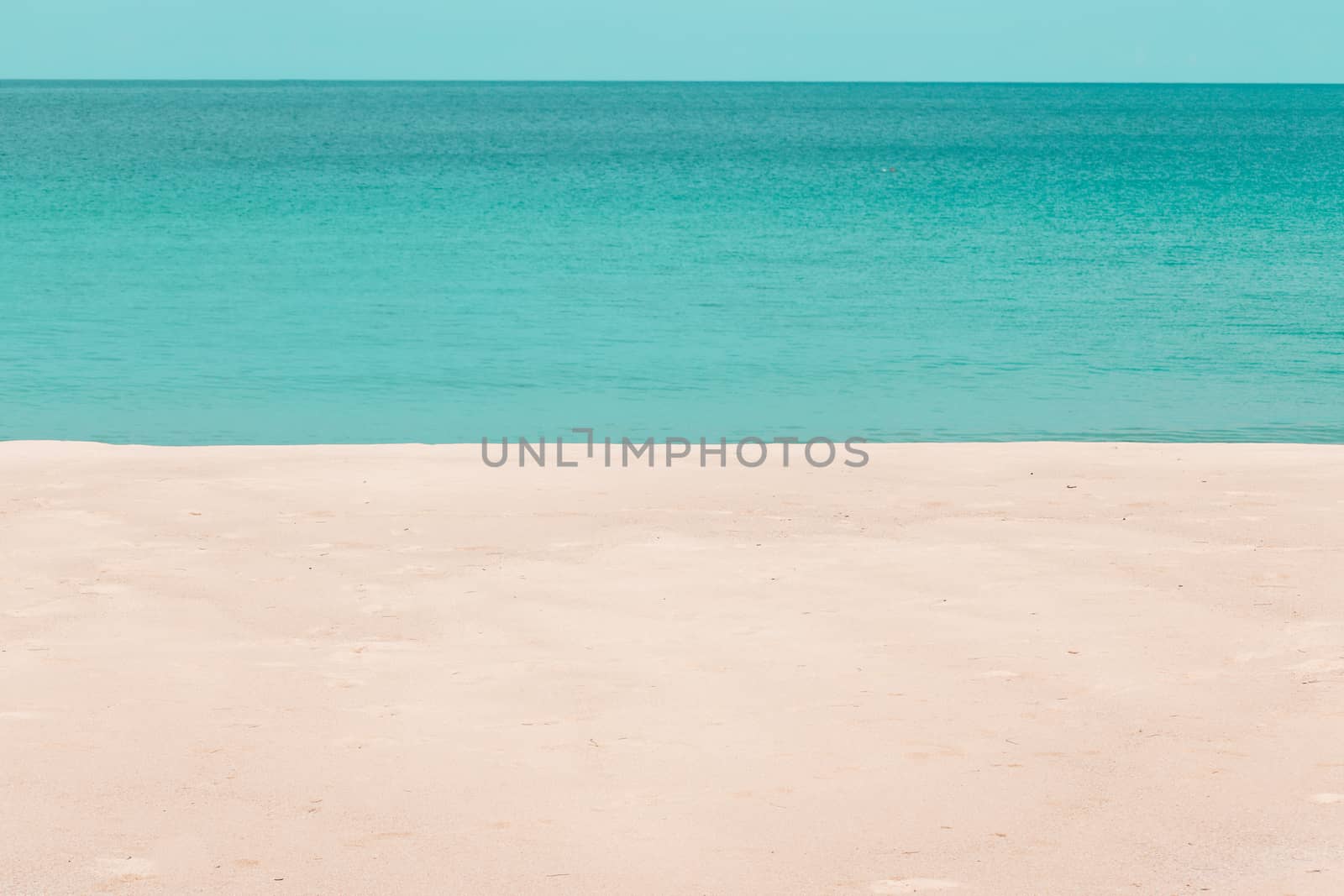 white sandy beach and turquoise sea water on sunny day