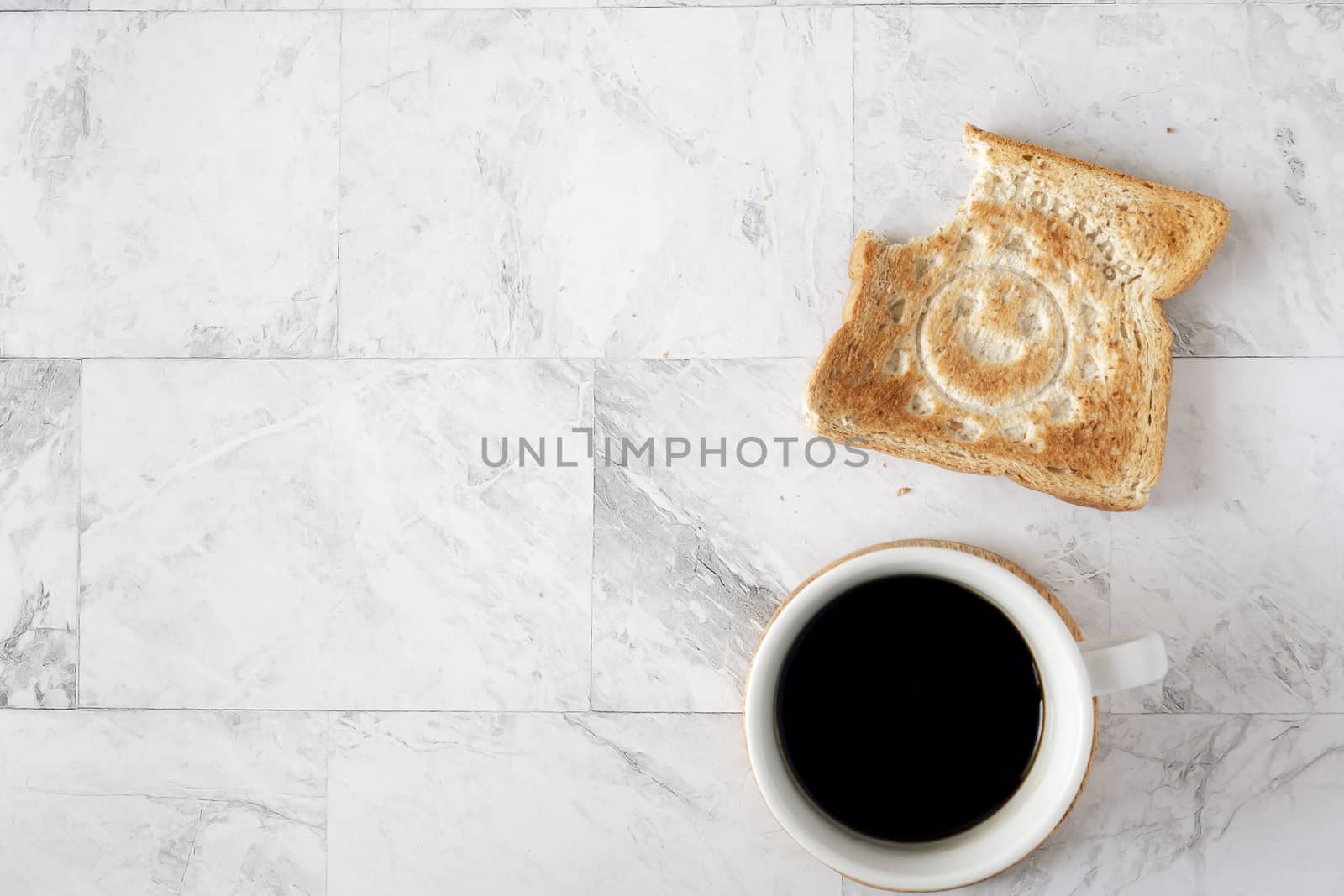Topview flat lay of working table with coffee and toast bread.  by ijeab