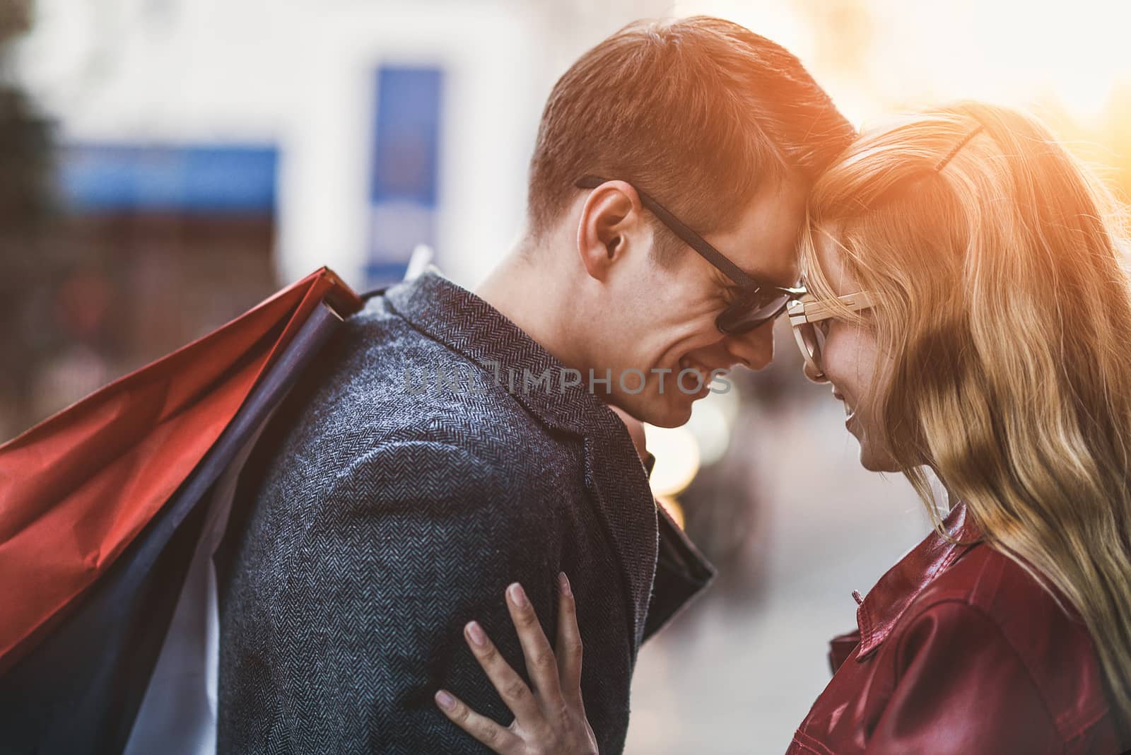 Picture showing young couple shopping in the city. Portrait of a couple with shopping bags in the city.People, sale, love and happiness concept.