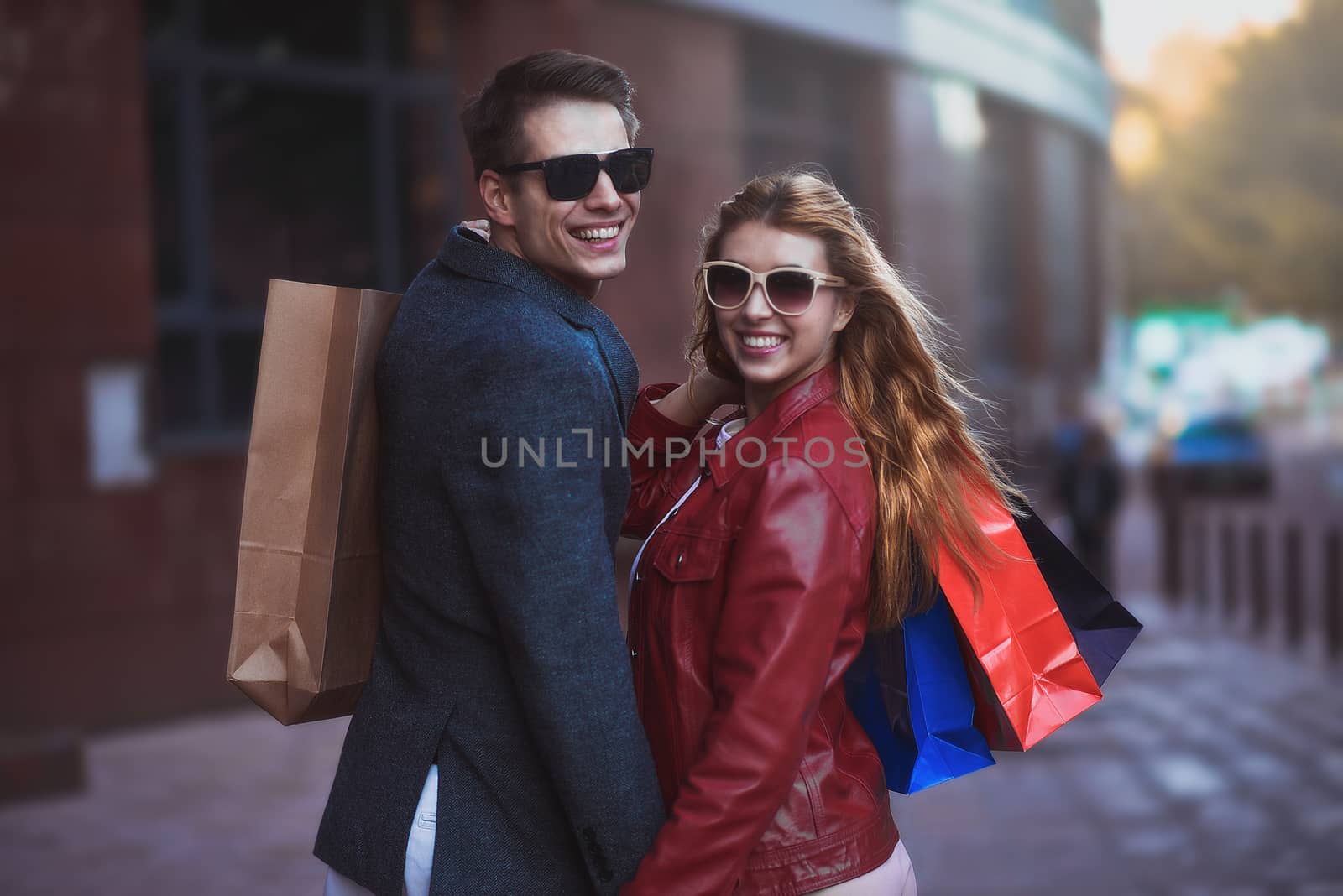 Picture showing young couple shopping in the city. Portrait of a couple with shopping bags in the city.People, sale, love and happiness concept.