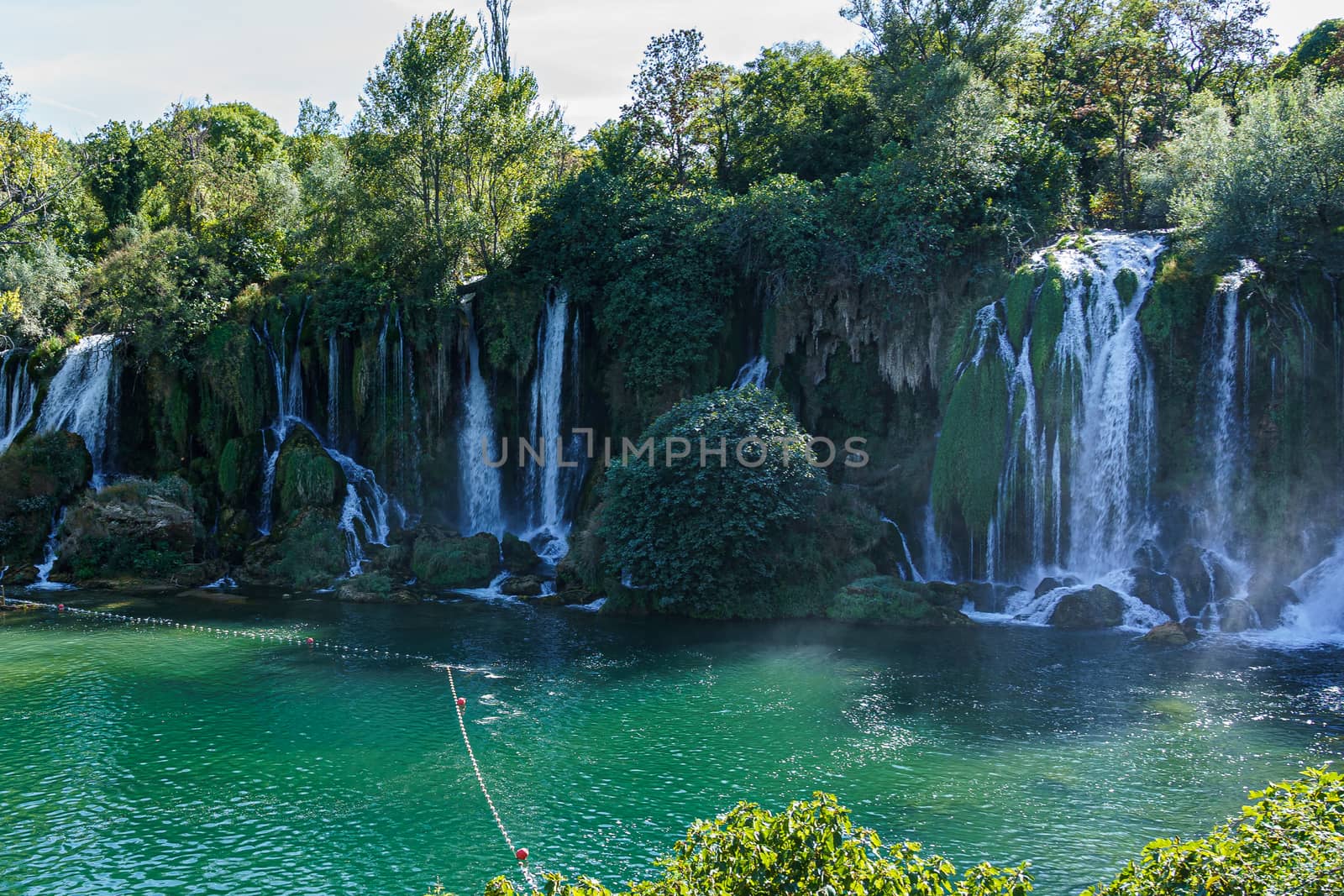 Kravice waterfall in Bosnia and Herzegovina, jets of water falling from a height of twenty-five meters among greenery