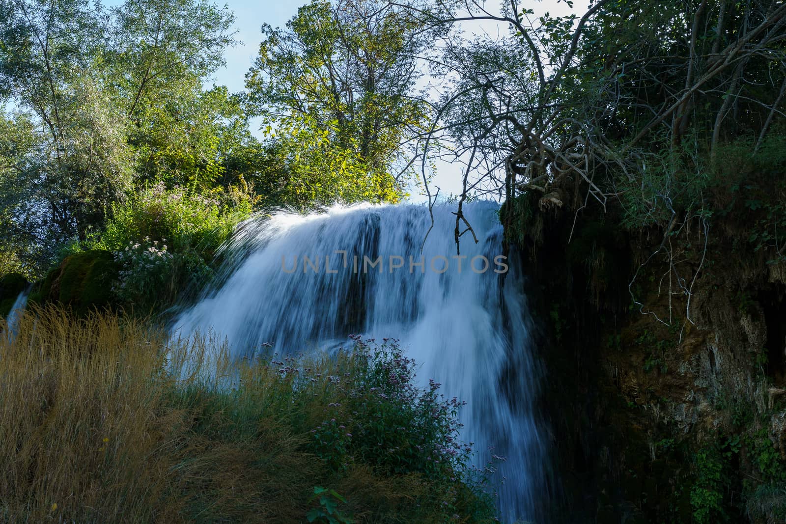 Kravice waterfall in Bosnia and Herzegovina, jets of water falling from a height of twenty-five meters among greenery