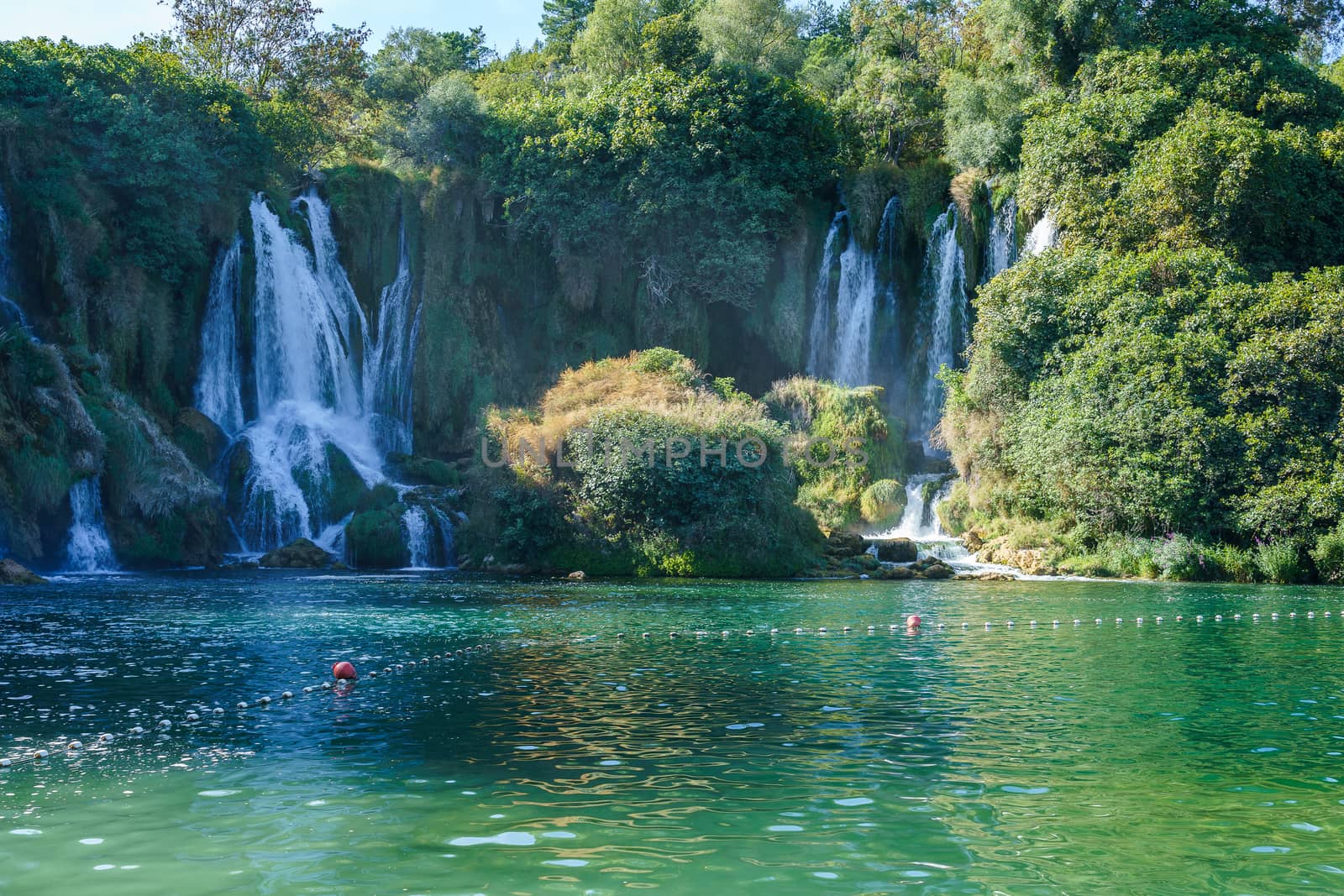 Kravice waterfall in Bosnia and Herzegovina, jets of water falling from a height of twenty-five meters among greenery