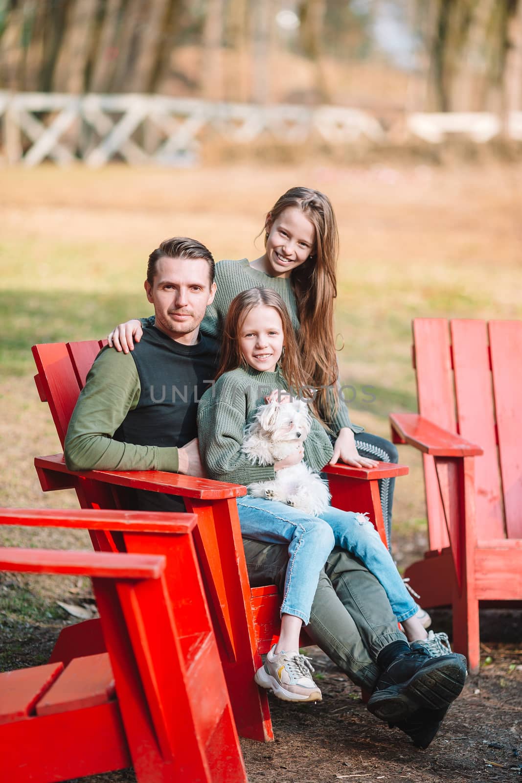 Father and cute daughters with dog outdoors by travnikovstudio