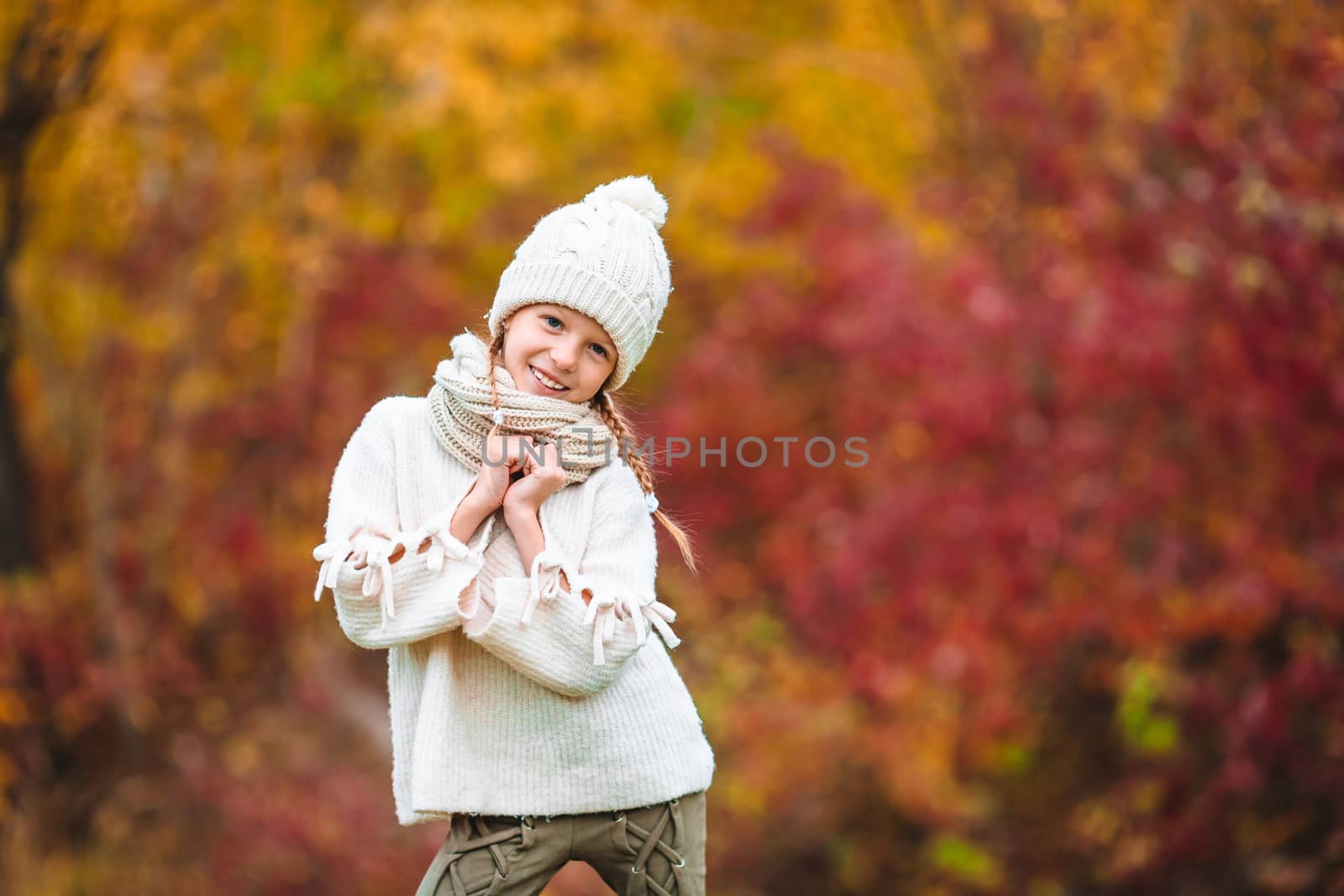 Adorable little girl at beautiful autumn day outdoors by travnikovstudio