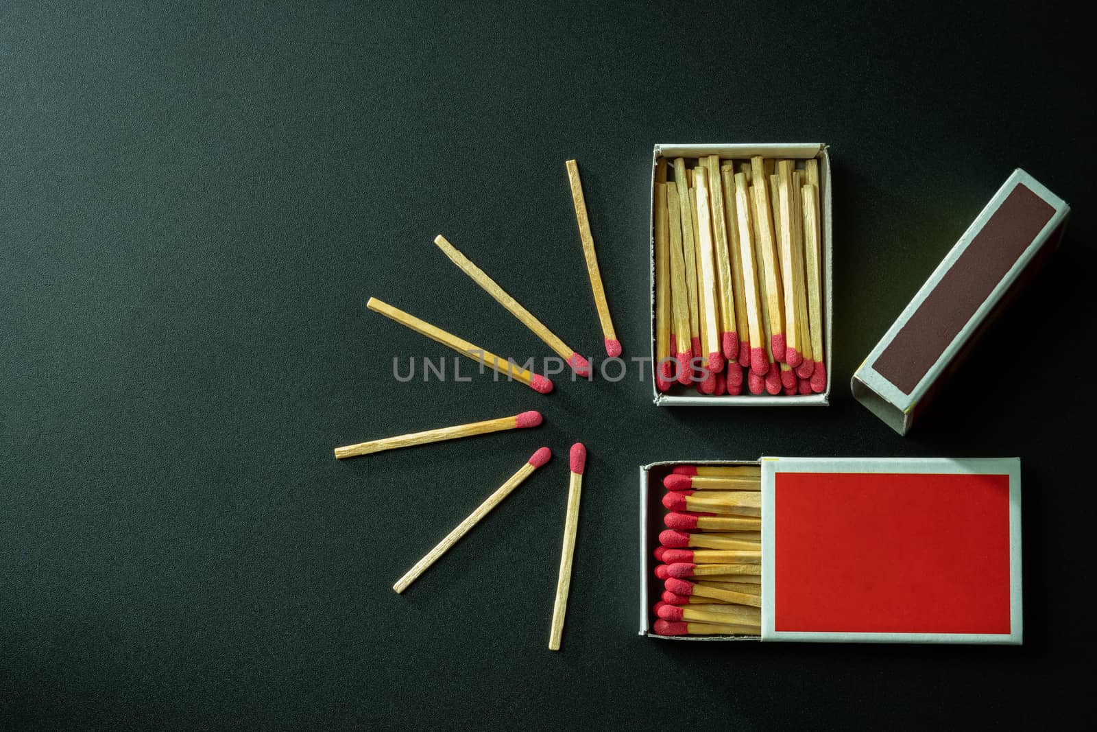 Box matches stick in red paper box on black background. Top view and copy space.