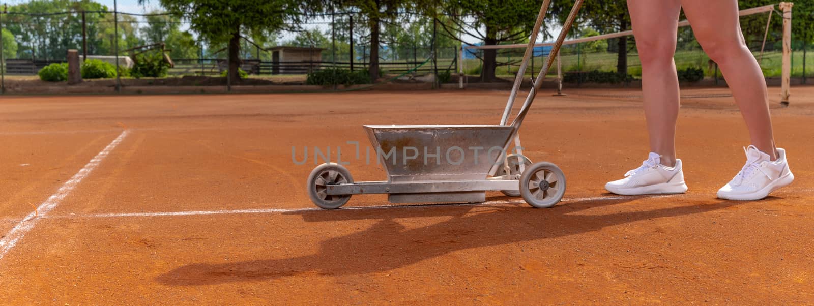 maintenance and repair of tennis courts. drawing white lines with lime by Edophoto